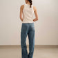 back of a woman wearing white tank and blue jeans