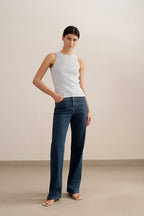 woman wearing a blue tank and blue jeans