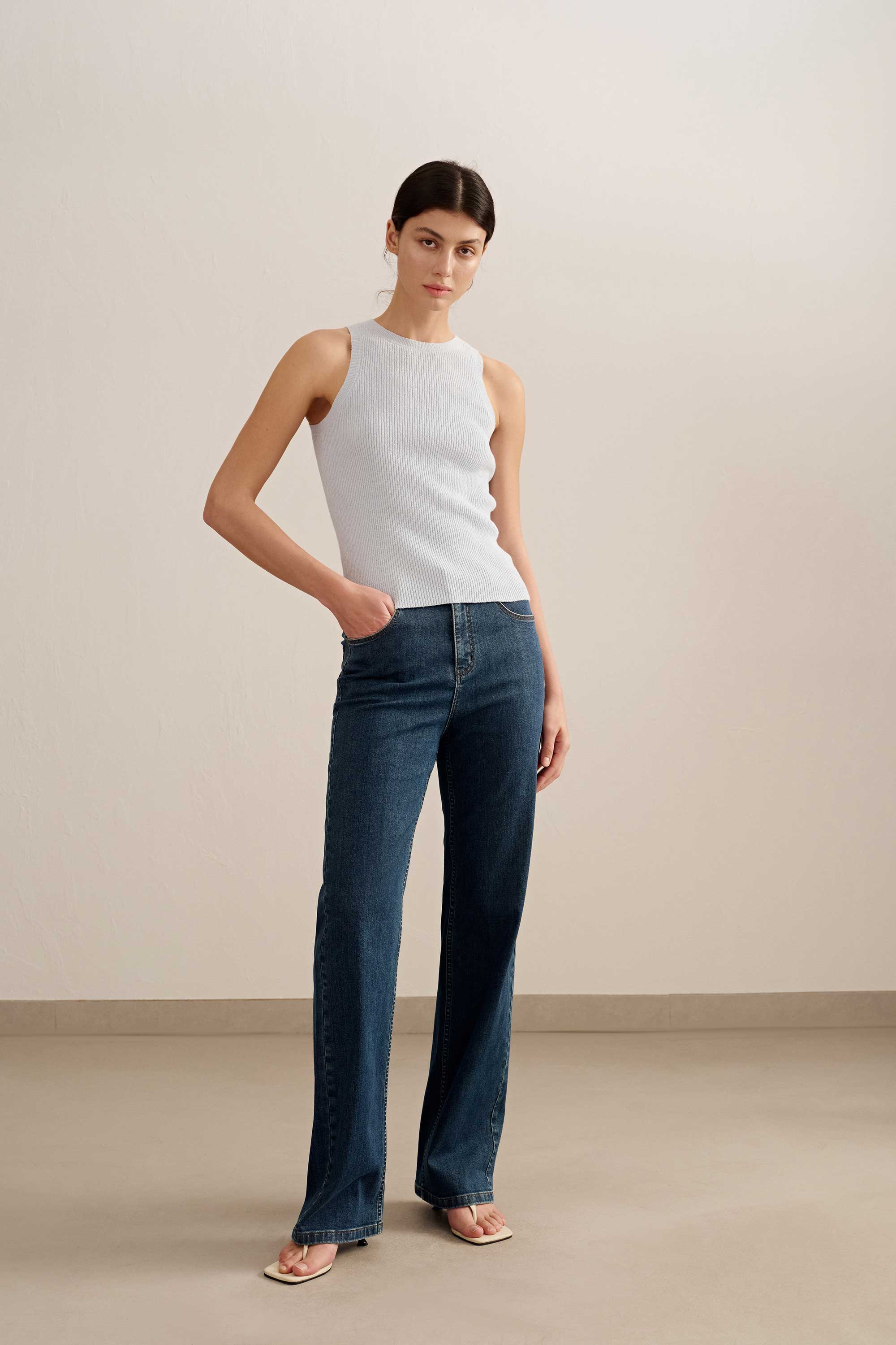 woman wearing a blue tank and blue jeans