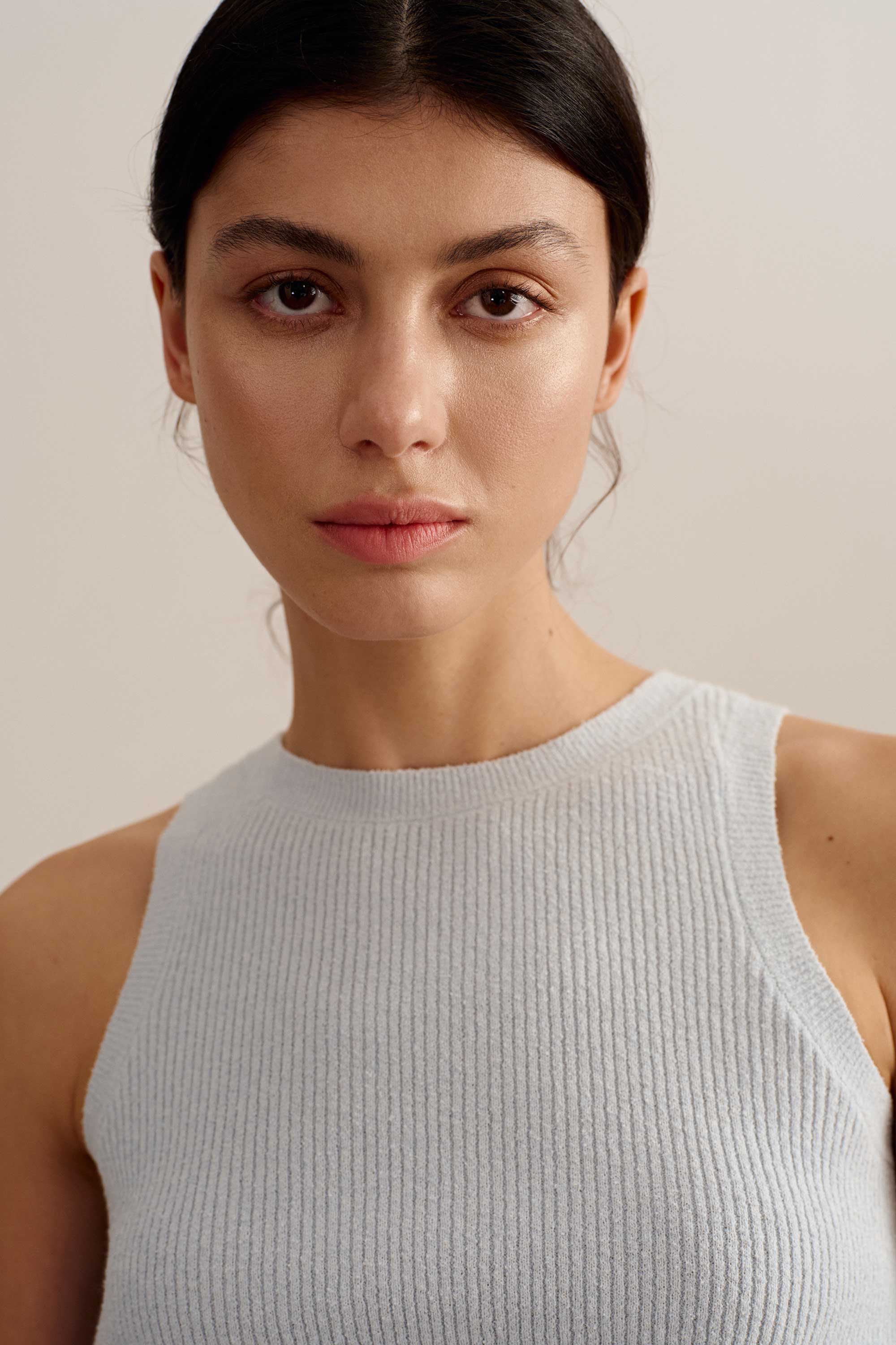 closeup shot of a woman wearing a blue tank