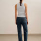 back of a woman wearing a blue tank and blue jeans