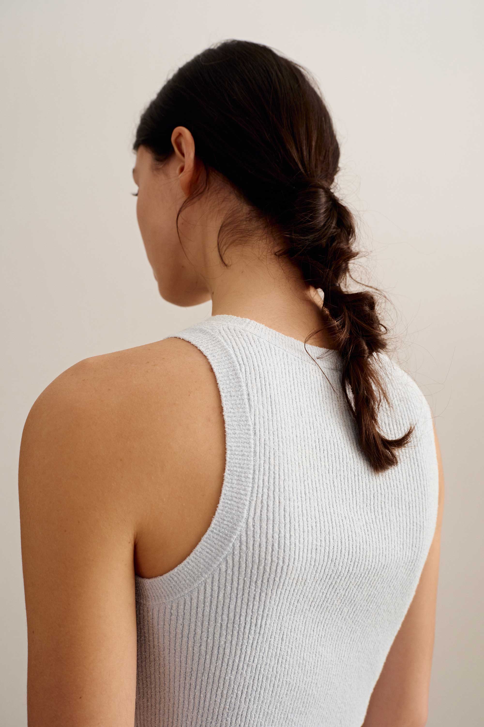 back of a woman wearing a blue tank