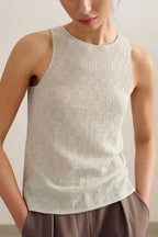 a woman wearing a light blue tank