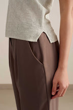side detail of light blue tank with dark brown pants