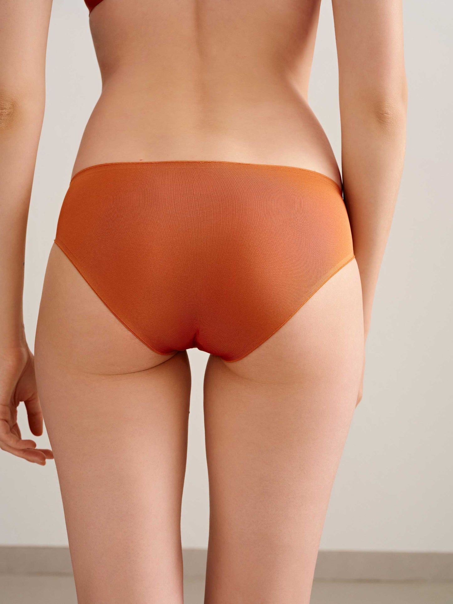 back of woman in orange brief