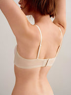 back of woman in off white bra