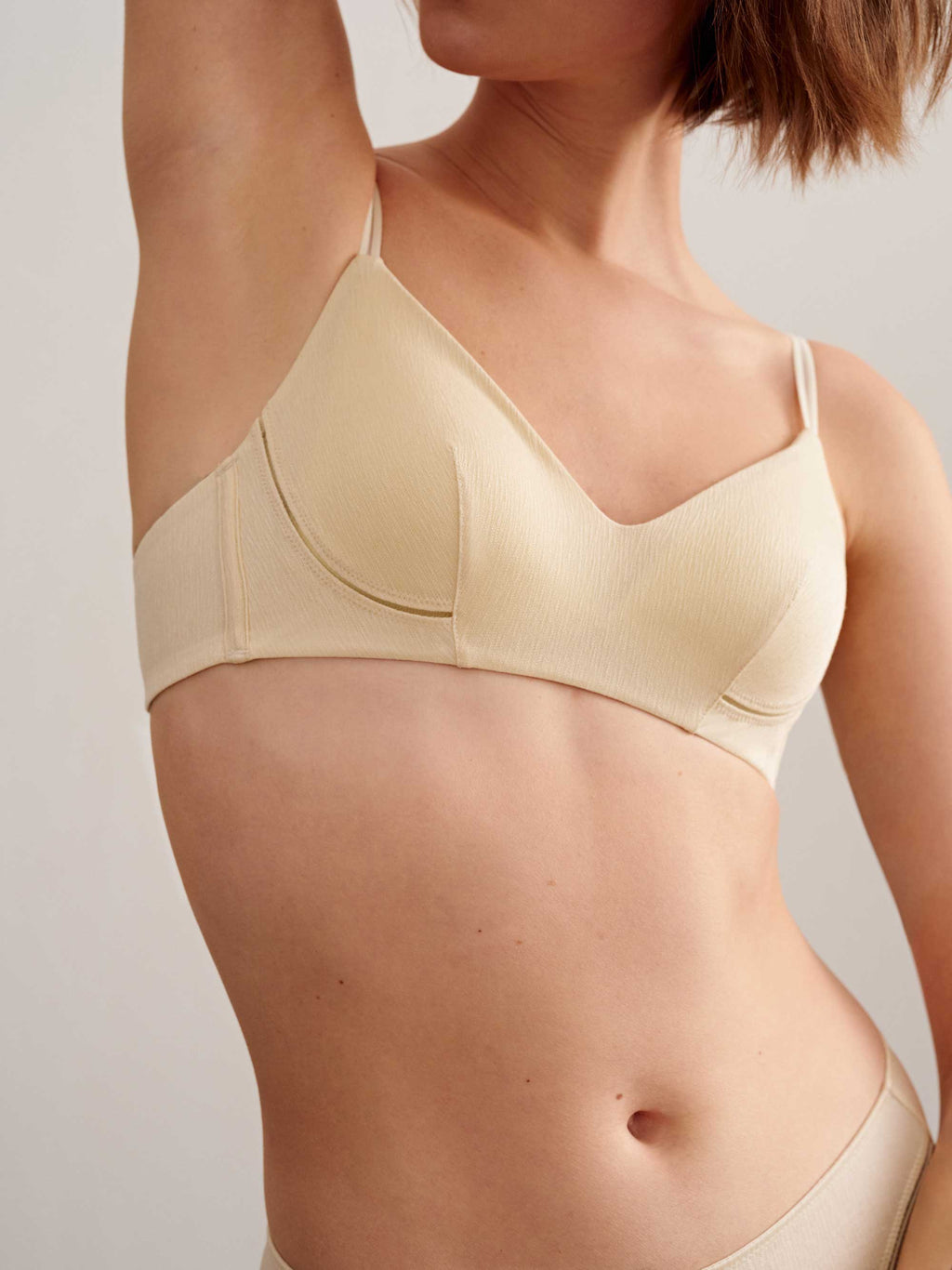 a woman wearing light beige bra.