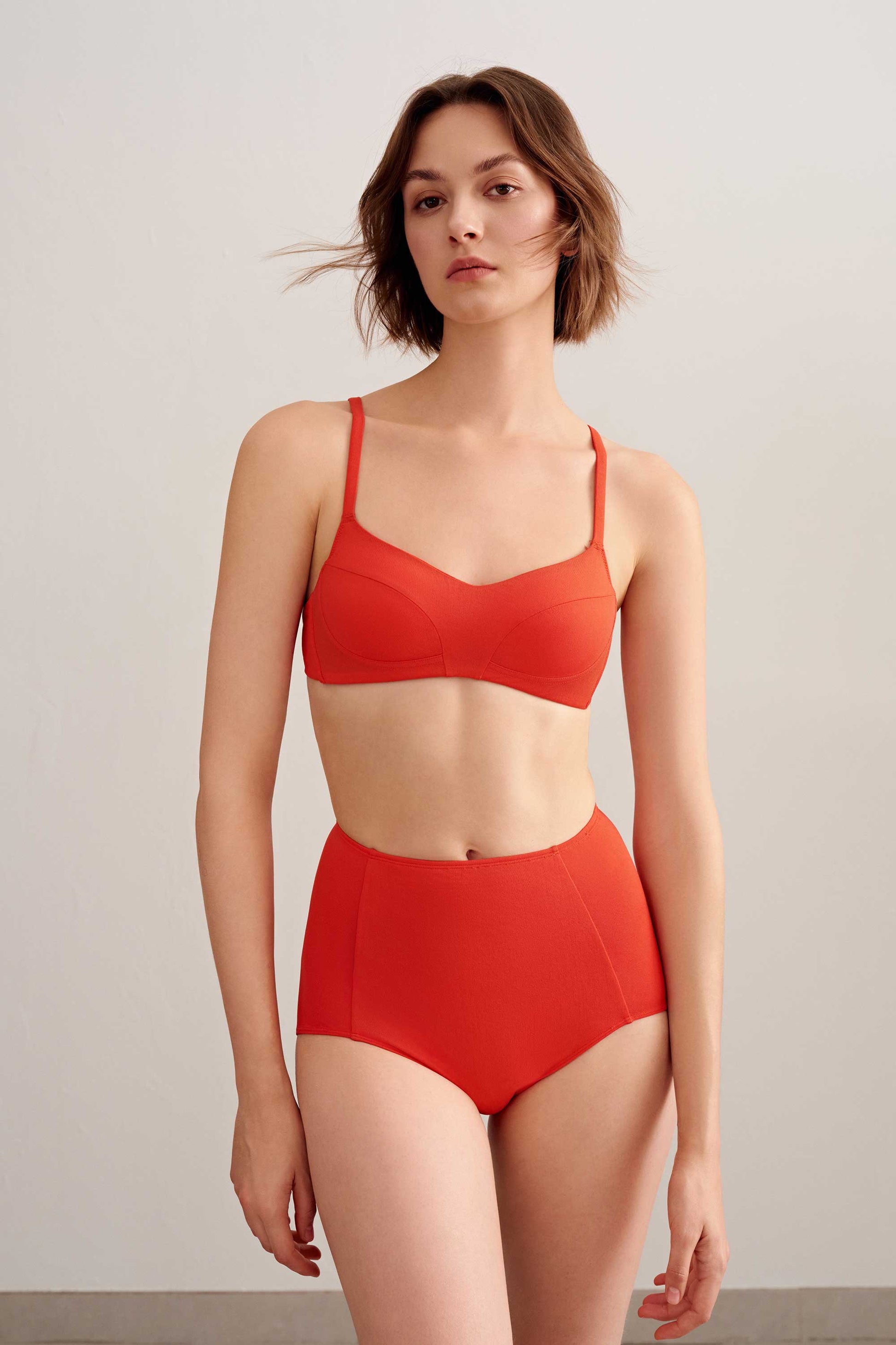 woman in orange bikini top and bottoms