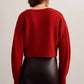 back of a woman wearing a red knot cardigan