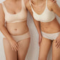 Two models wearing nude bra and brief set.