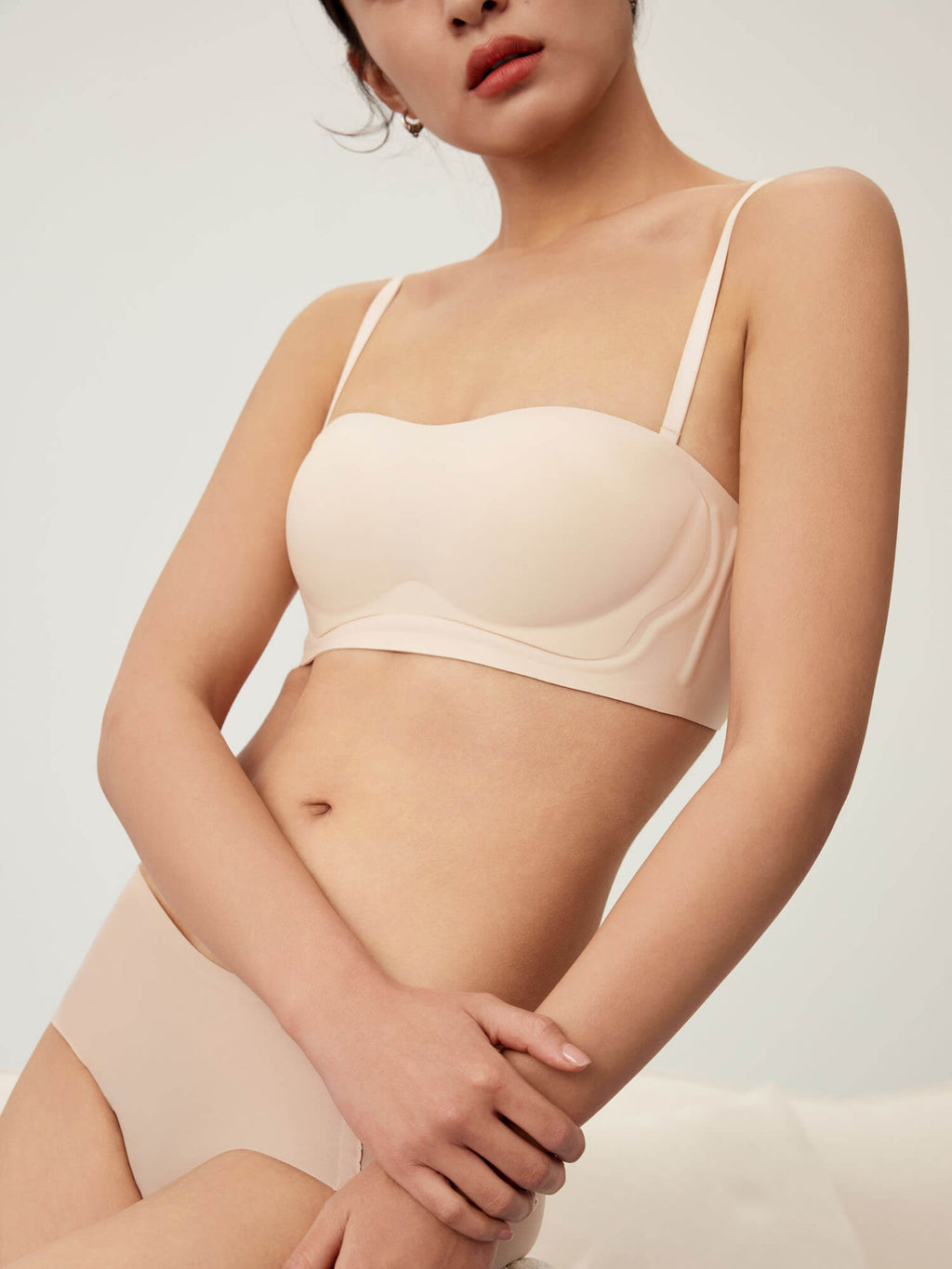 Model wearing white bandeau bra and briefs. Treacly Almond color.