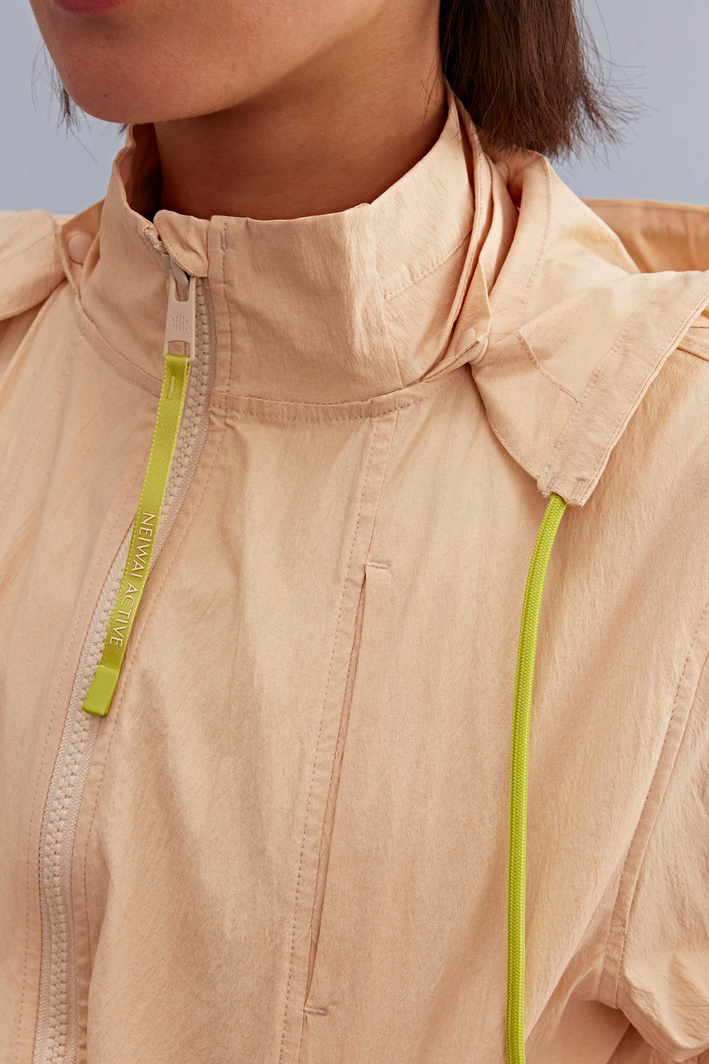 detail of the warm yellow jacket with green strings. 