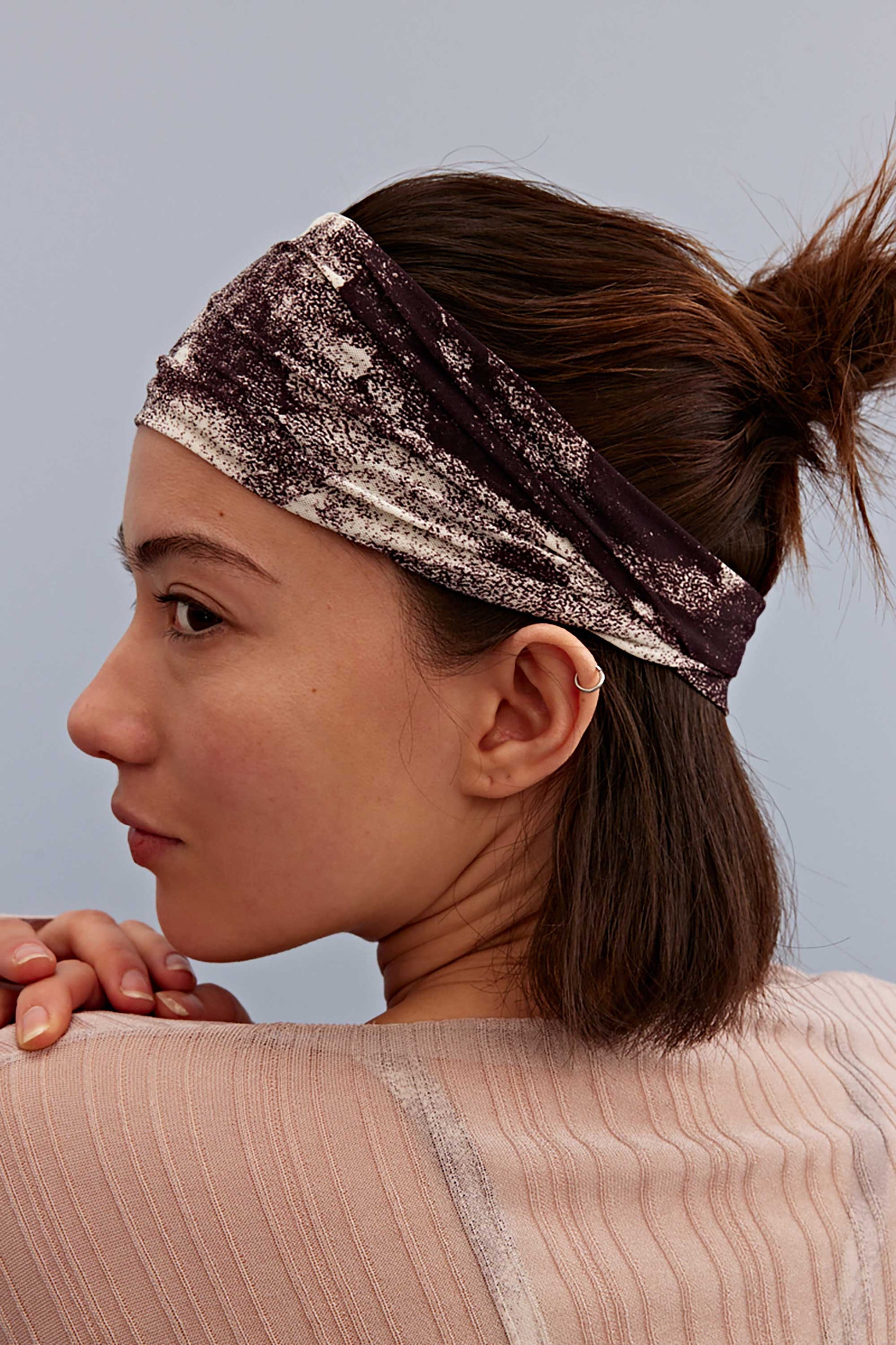 a woman wearing a metallic hairband