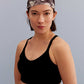 a woman wearing a metallic headband and black sports bra