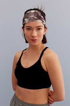 a woman wearing a metallic headband and black sports bra