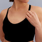 a woman holding the strap of the black sports bra