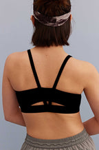 back of a woman wearing metallic headband and black sports bra