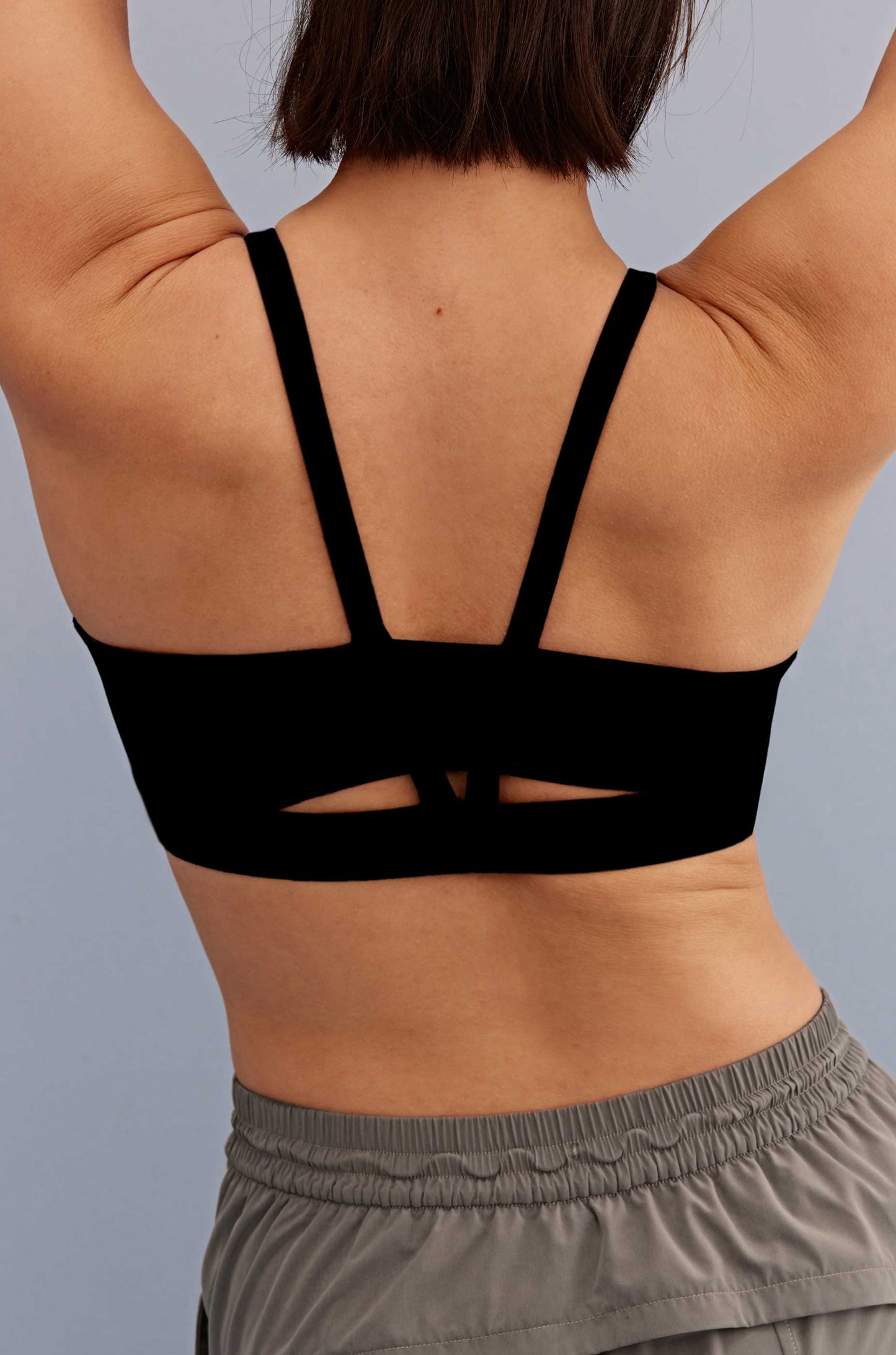 back of a woman wearing a sports bra with V back shape