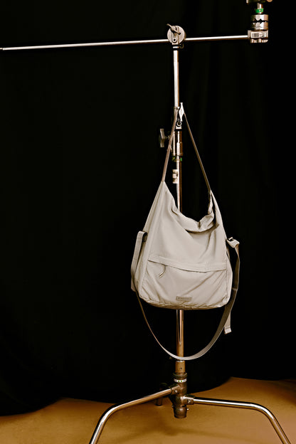 a grey bag hang on the rack