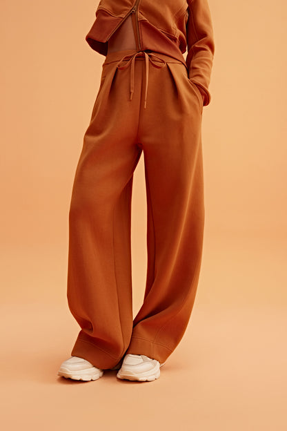 woman in caramel wide leg pants