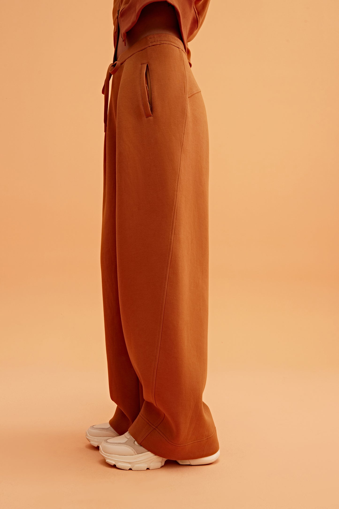 side of woman in caramel wide leg pants