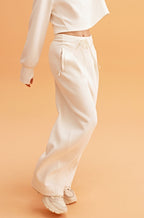woman in white sweatshirt and wide leg pants