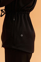 detail shot of the black hooded jacket shown neiwai active logo