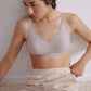 Woman wearing light gray bra with plunge neckline