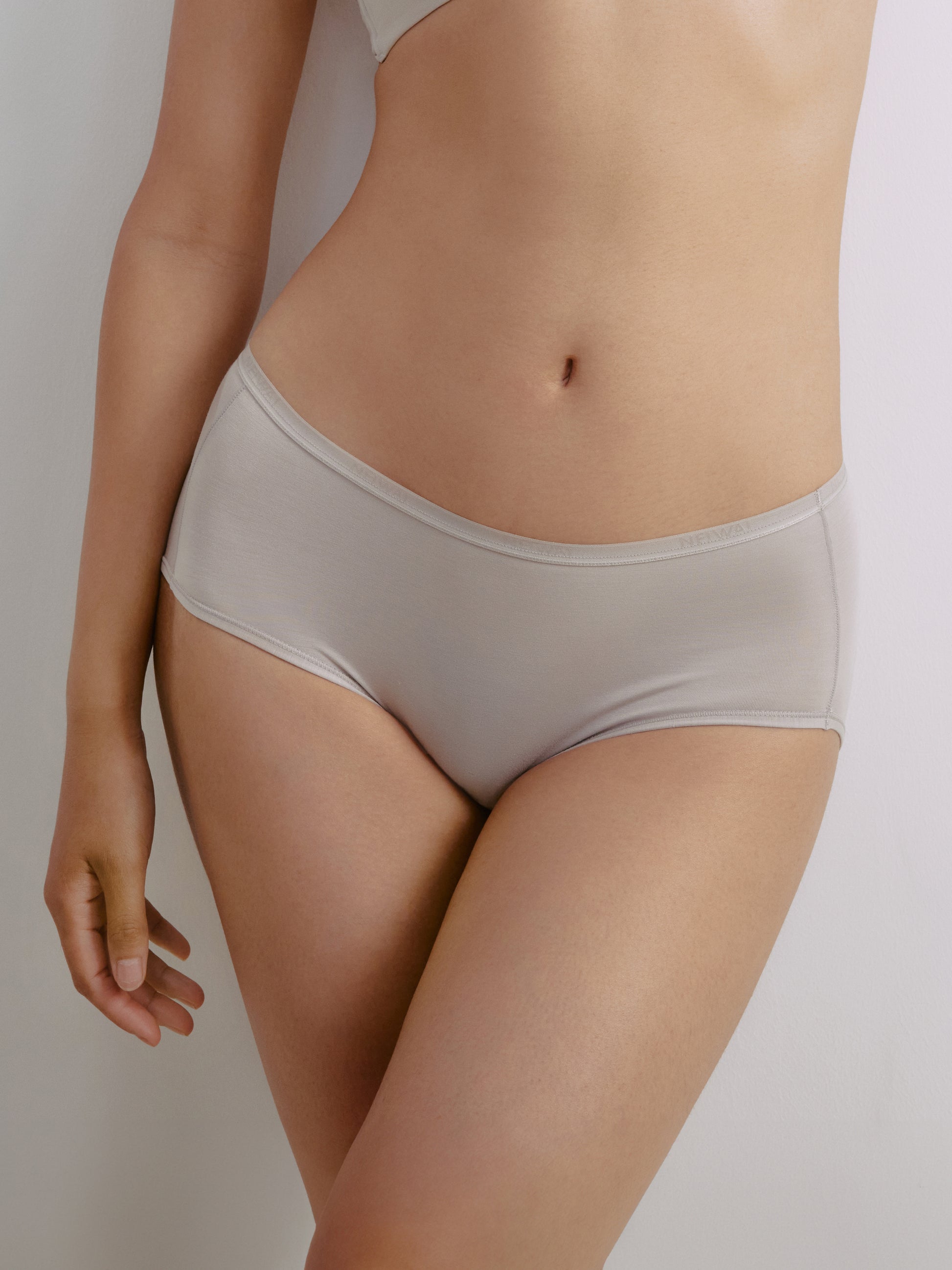 Closeup of woman wearing gray briefs