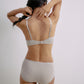 Back view of woman wearing gray plunge bra and matching brief