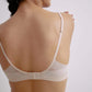 Back view of a nude 3/4 cup bra worn by a model, showing adjustable straps and a back closure, with sheer mesh detailing around the band.