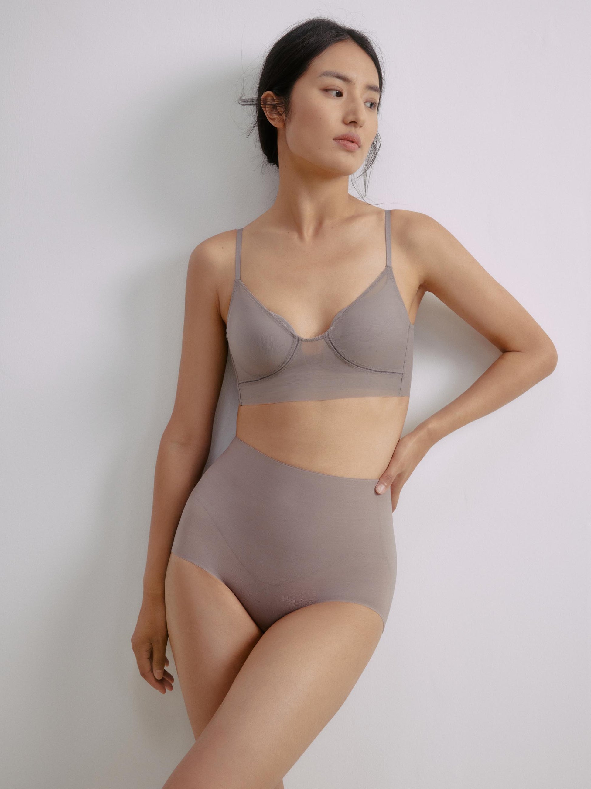 Front view of a model wearing a gray purple bra paired with high-waisted seamless briefs.