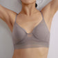 Front view of a model wearing a gray  purple bra with sheer mesh detailing, arms raised above the head, showcasing the bra’s fit and design.