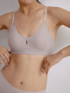 Closeup of woman wearing light gray bra with center cutout detail. Sphinx color.
