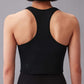 The image depicts the back view of a person wearing a black racerback sports bra top. The top has a close fit and the fabric appears smooth and lightweight. 