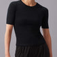 A woman wearing black short sleeve round neck T-shirt and black pants. 