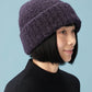 side view of woman wearing purple beanie