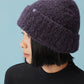 side view of woman wearing purple beanie