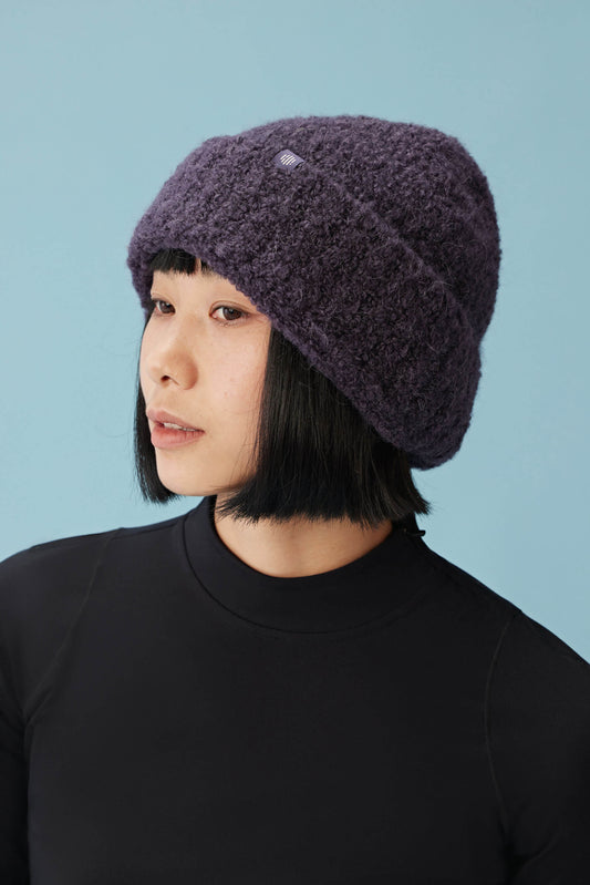 woman wearing purple beanie