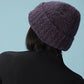 back of woman wearing purple beanie