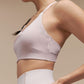 Side view of model wearing light pink sports bra.