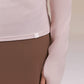 Close up of light pink long sleeve top.