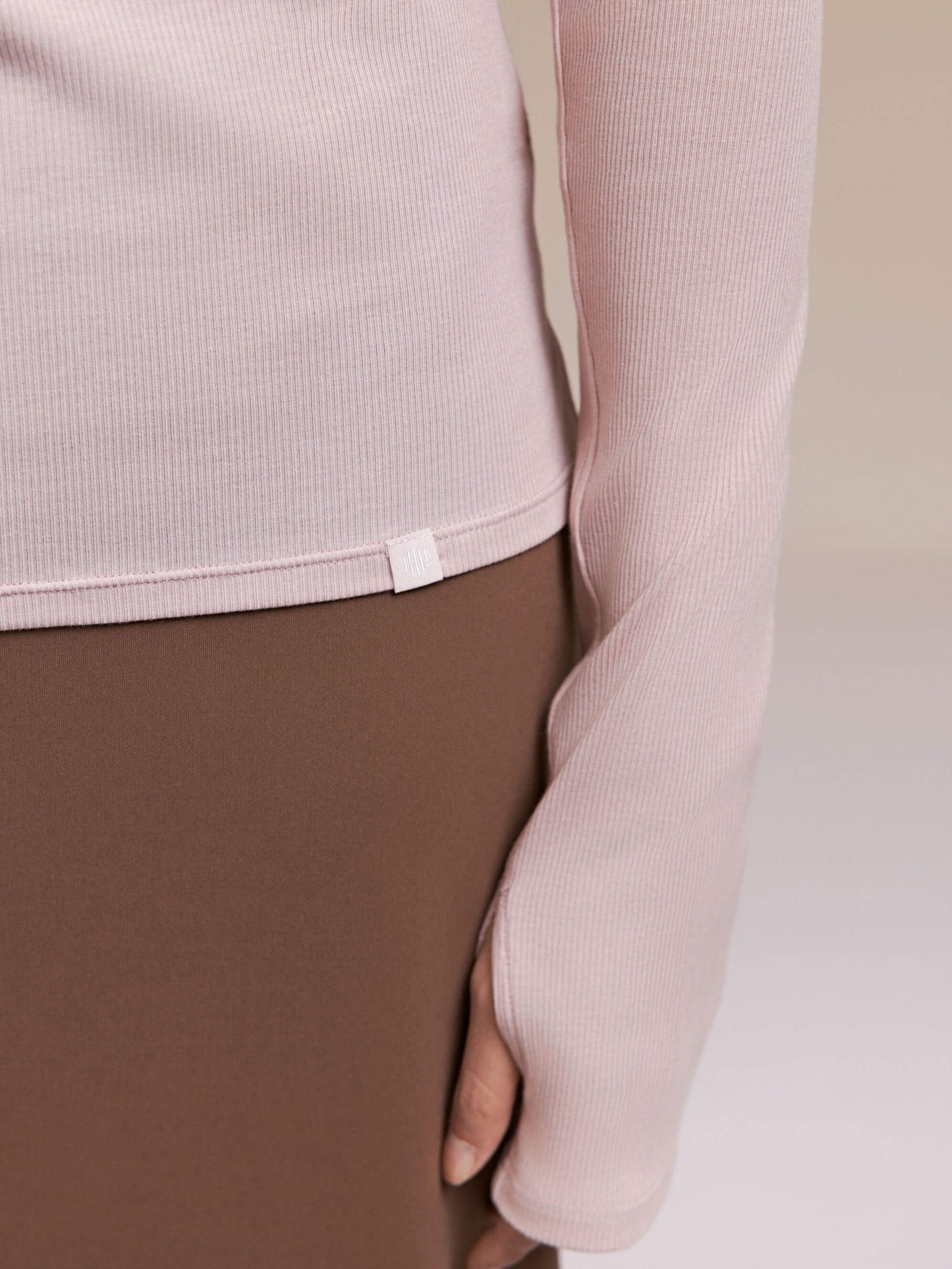 Close up of light pink long sleeve top.