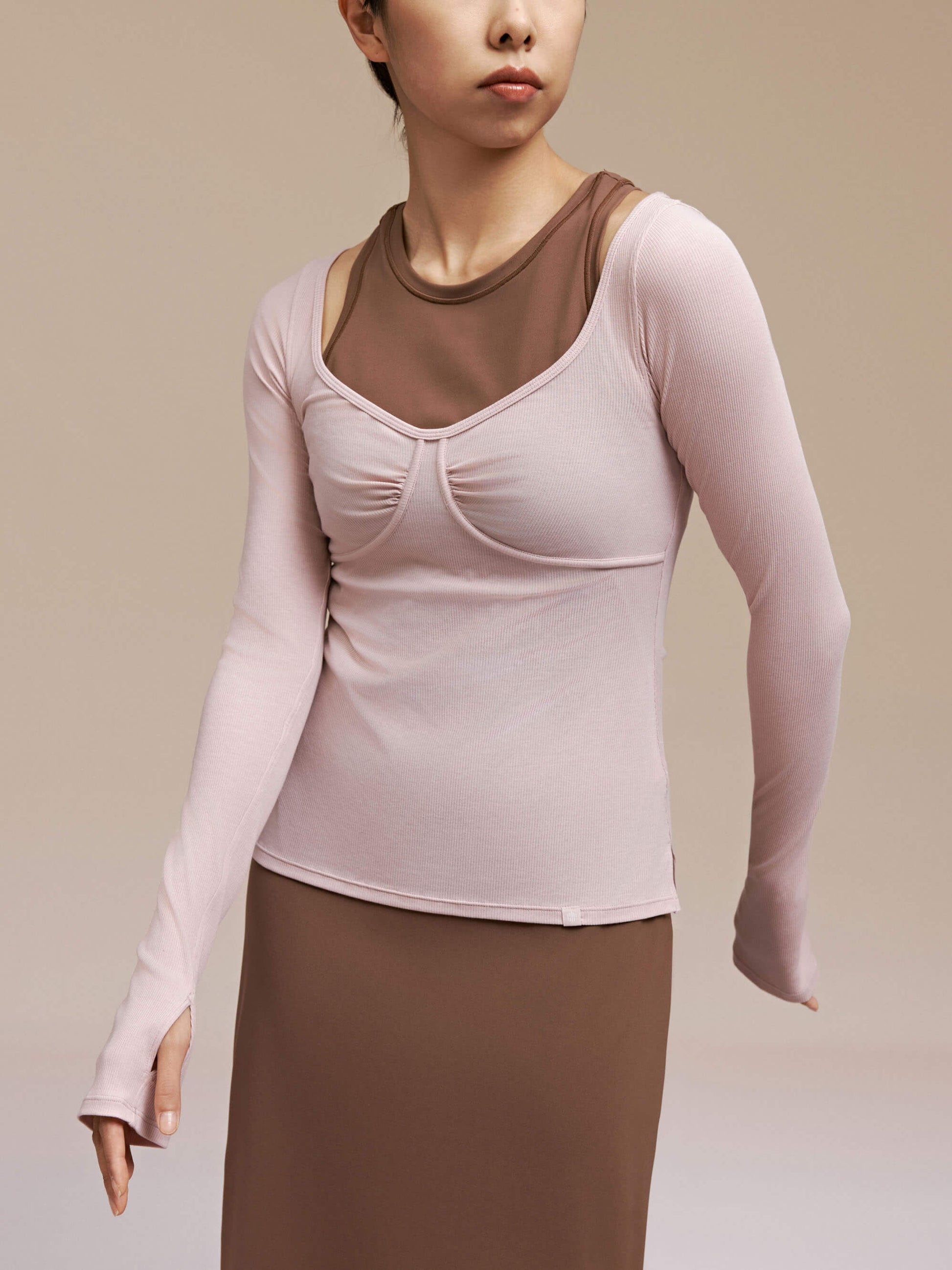 front view of woman wearing light pink long sleeve top