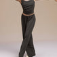 Front view of model wearing black wide leg pants and dance top