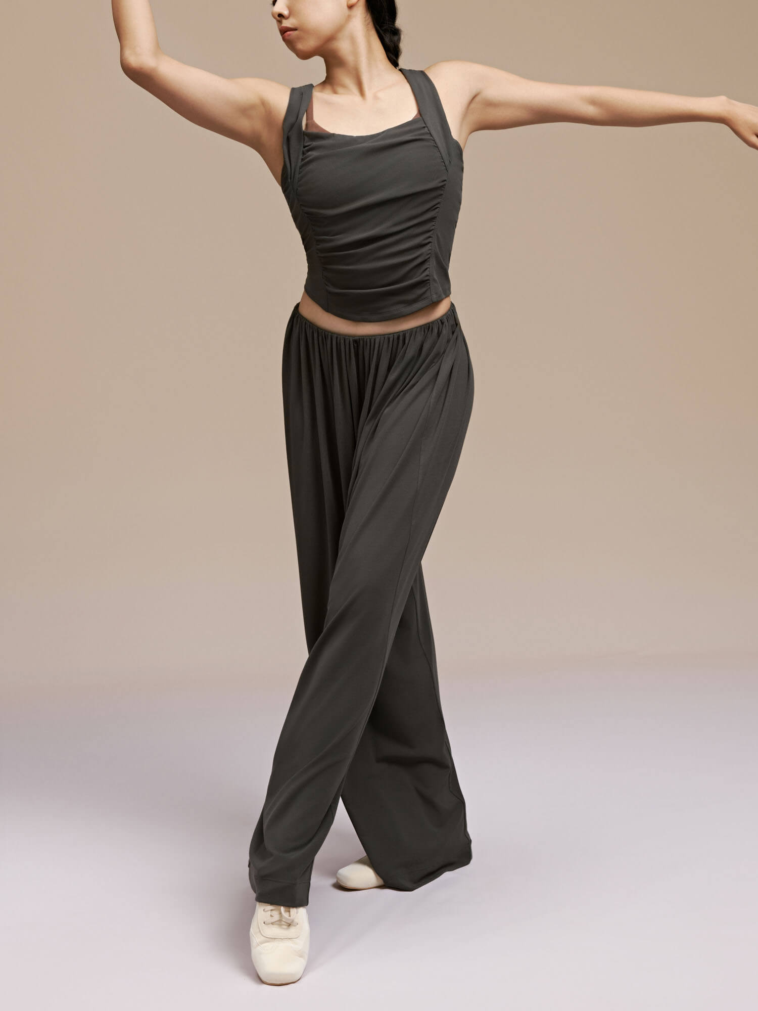 Front view of model wearing black wide leg pants and dance top