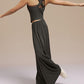 Side view of model wearing black wide leg pants and dance top