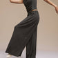 Side view of model wearing black wide leg pants and dance top