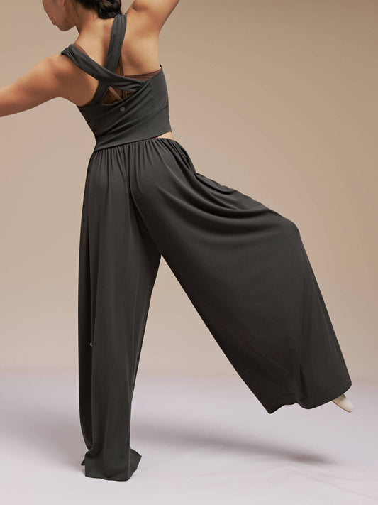 Back side of model wearing black wide leg pants and top