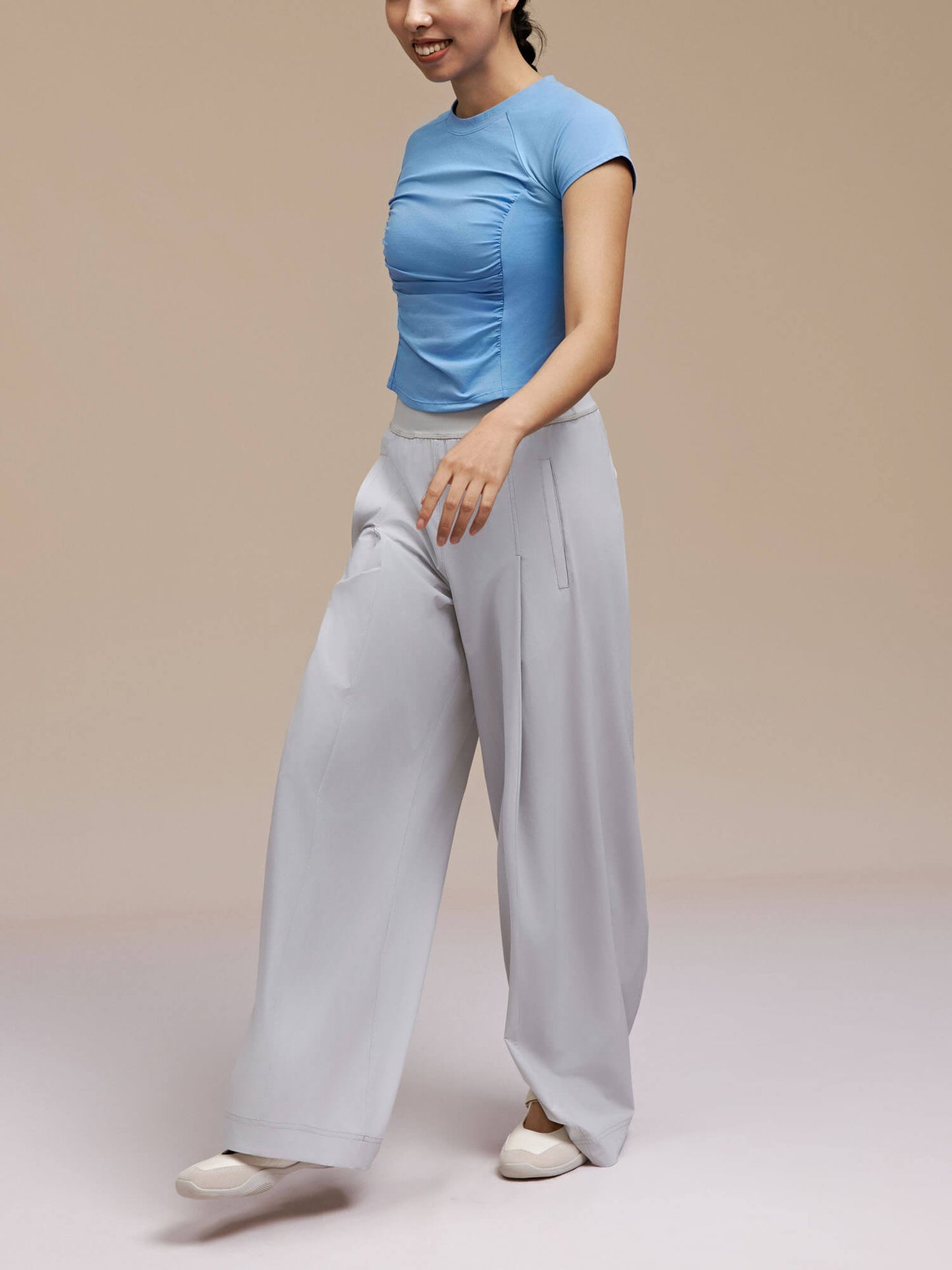 Model wearing light blue dance tee and gray pants